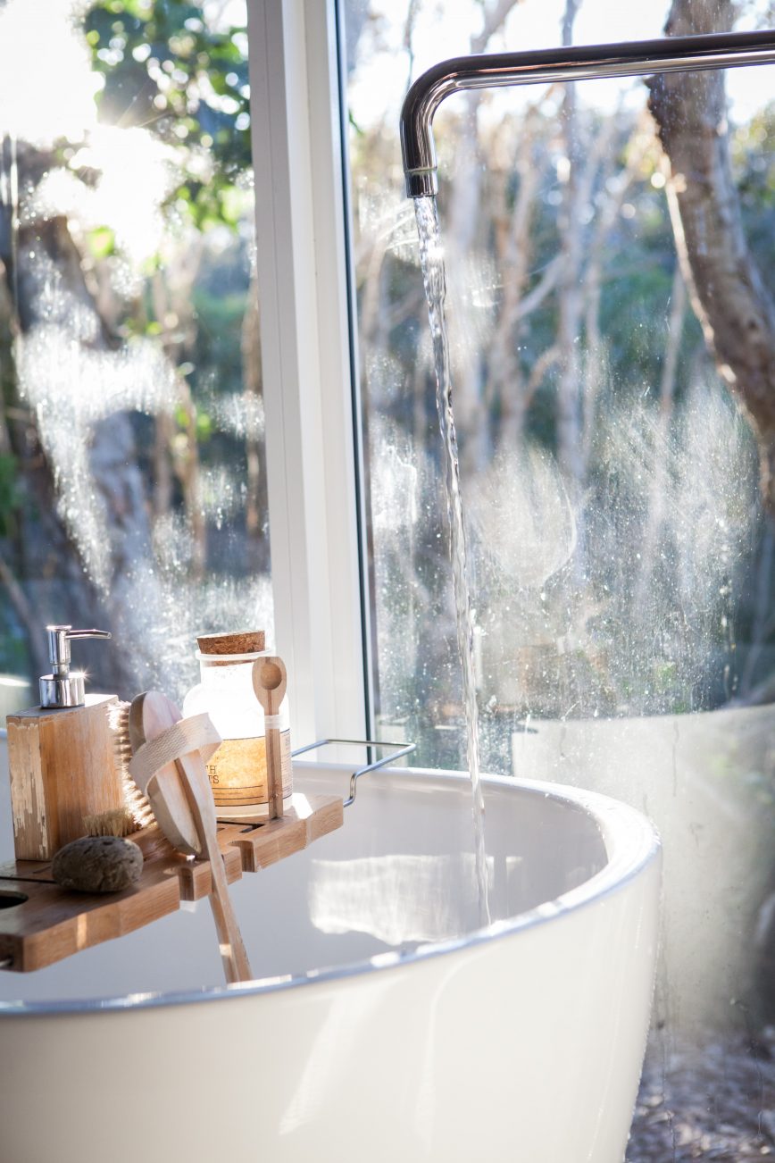 bath tub filling with bottles on edge