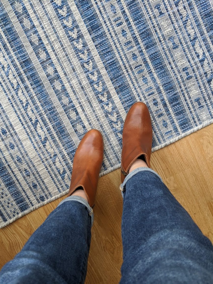 Brown boots on textile entry carpet